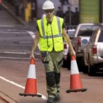 Orange safety cones and high visibility vest safety supplies.