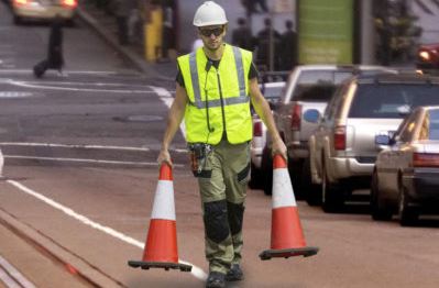 Orange safety cones and high visibility vest safety supplies.